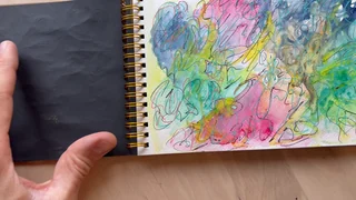 An open art pad with overlapping pink, blue, yellow and green loops