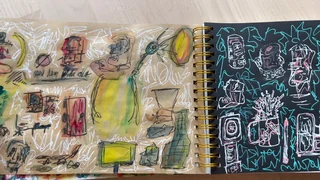 A used sketchbook spread with colored shapes on kraft paper and fine doodles on a dark page