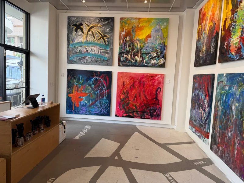 Paintings installed around the sunlit exhibition room at Kaiao Space