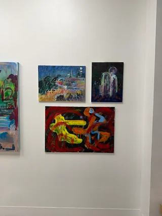 Paintings on a gallery wall at Sparkler Pinpricks